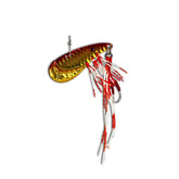Gold and red handcrafted fishing lure with feathered skirt and sharp hook on white background